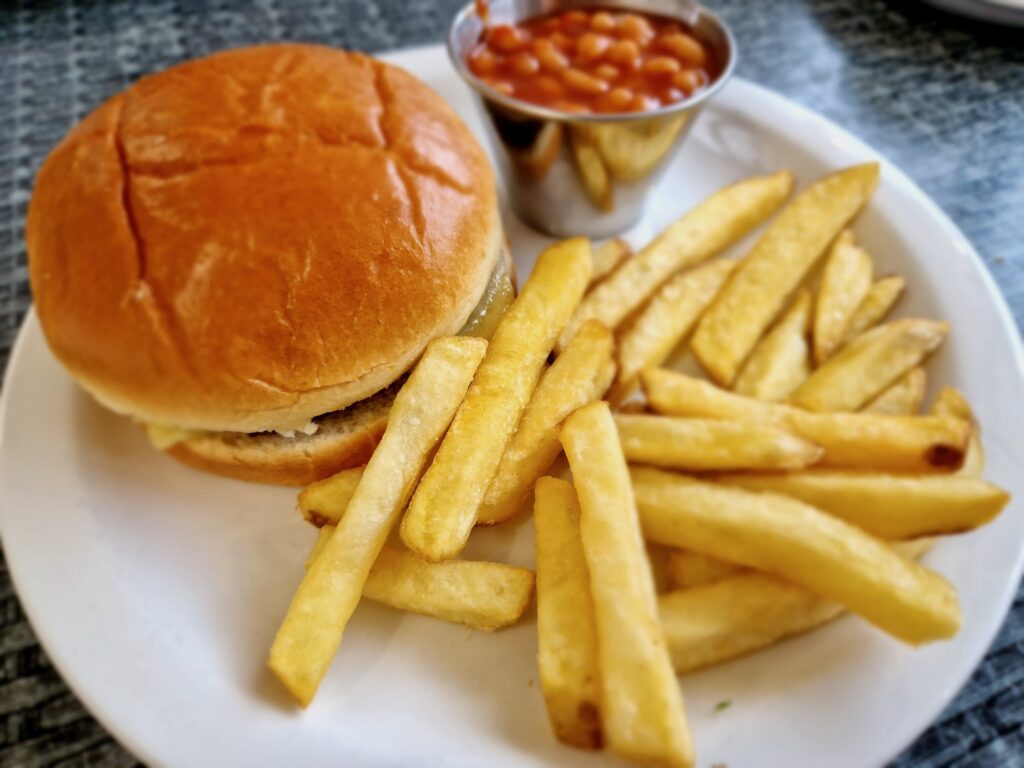 Children's cheeseburger meal from Sara's Tearooms. A small cheeseburger with chips and a pot of beans separate