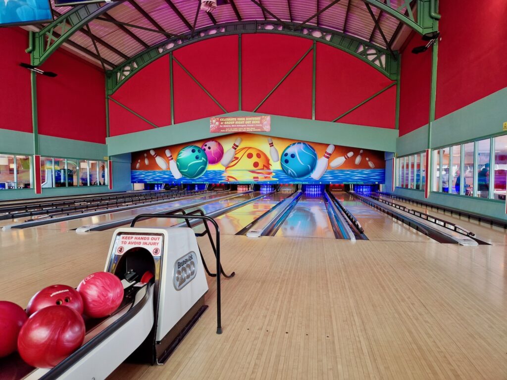 Bowling lanes with bowling balls to one side, at Wellington Bowl