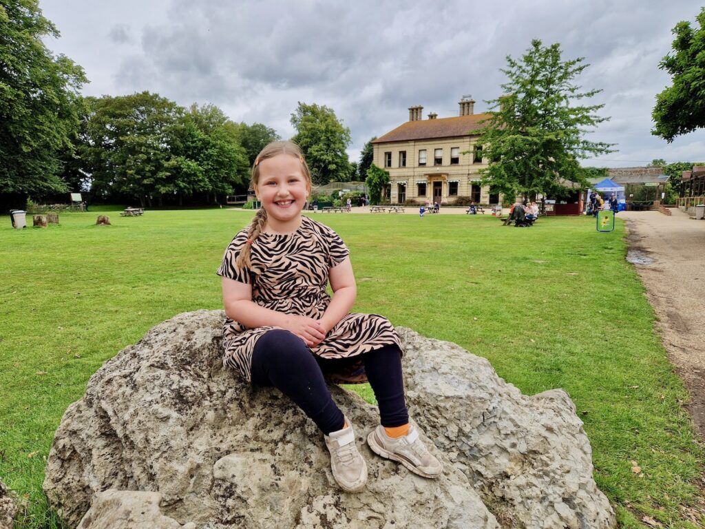 Erin sat on a rock in front of Thrigby Hall