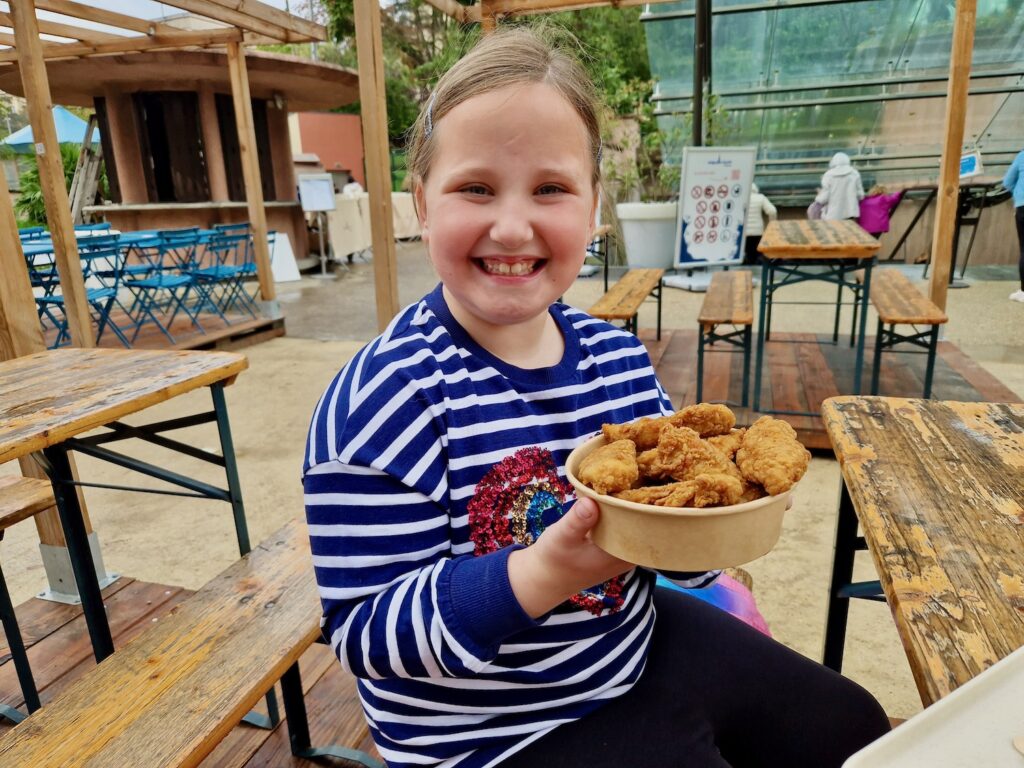 Erin with fried chicken outside Aquarium de Paris