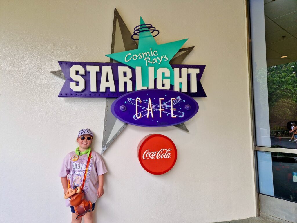 Erin stood outside Cosmic Ray's Starlight Cafe in Magic Kingdom