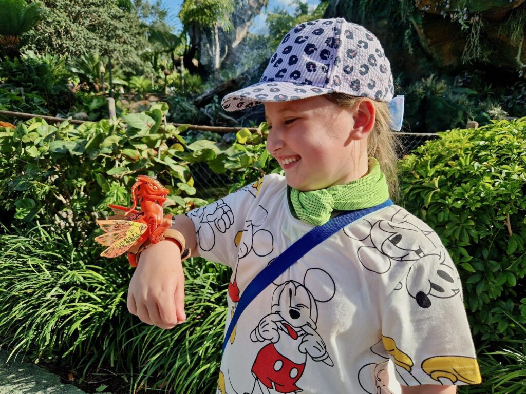 Erin with a toy Banshee on her wrist in Pandora at Animal Kingdom