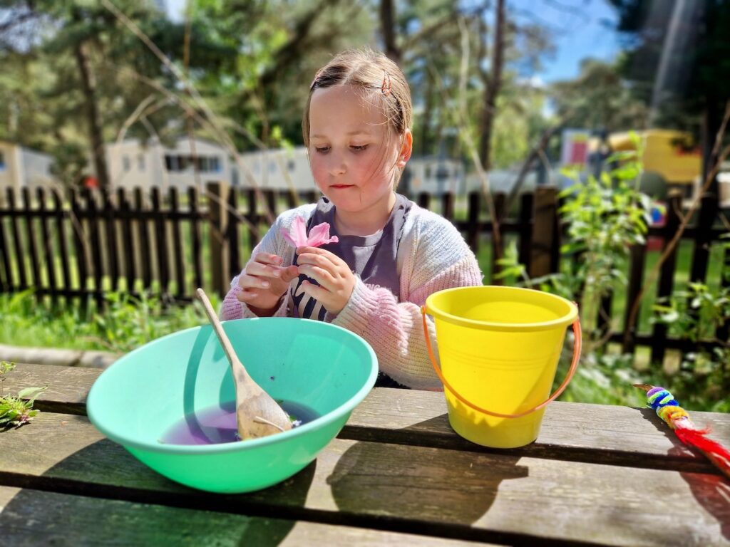 An 8 year old girl making a potion during a Wild Wizards session at Haven Wild Duck