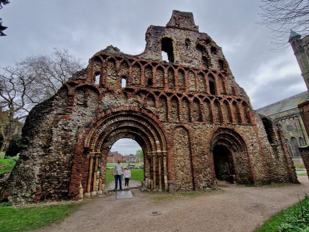 An 8 year old girl and her 40 year old Dad stood near the ruins in Colchester