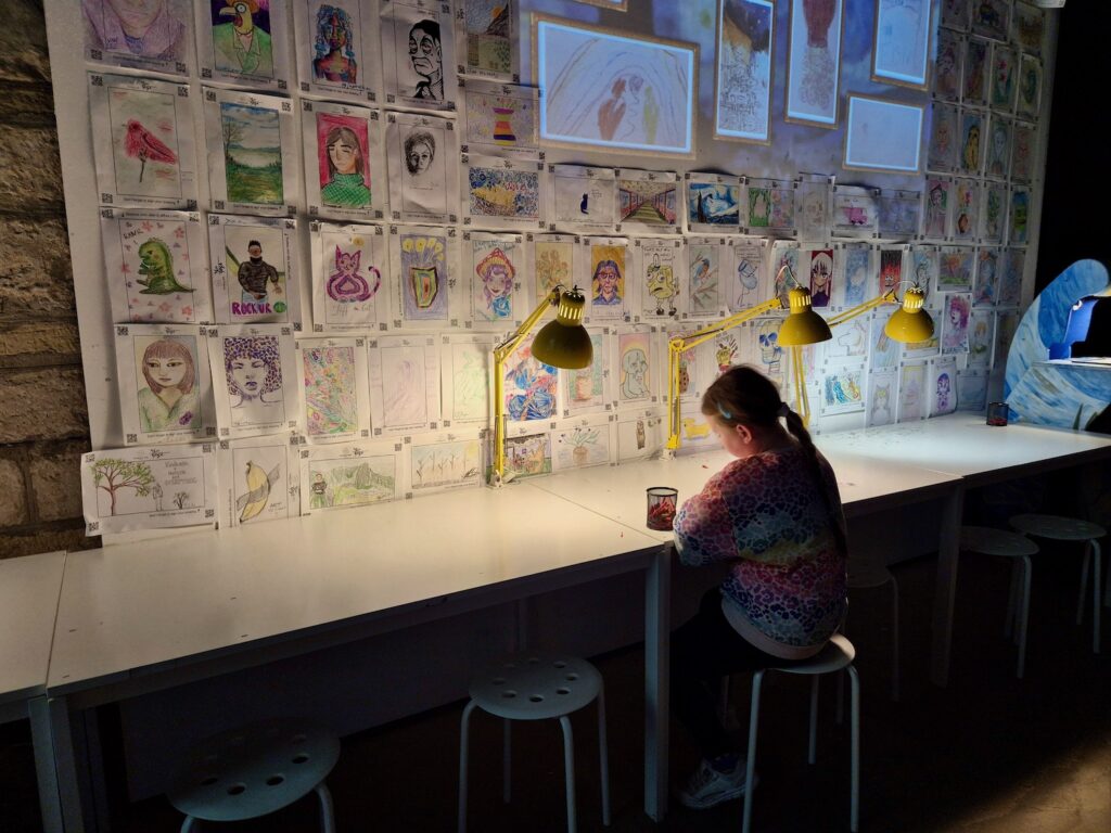 Erin drawing at the Van Gogh Immersive experience in York