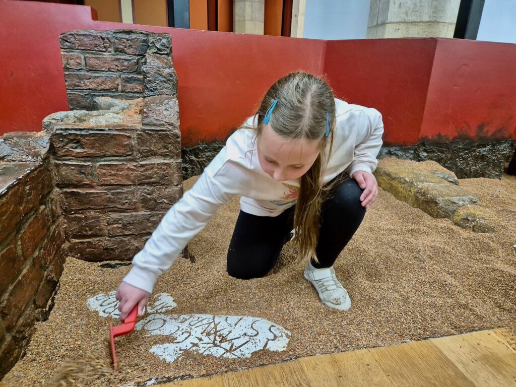 Erin at the DIG replica excavation site