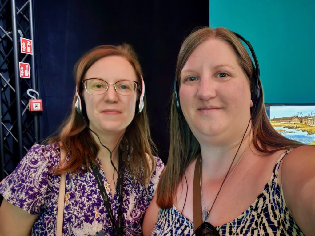 Sisters using audio guides at HistoryLand Poznan