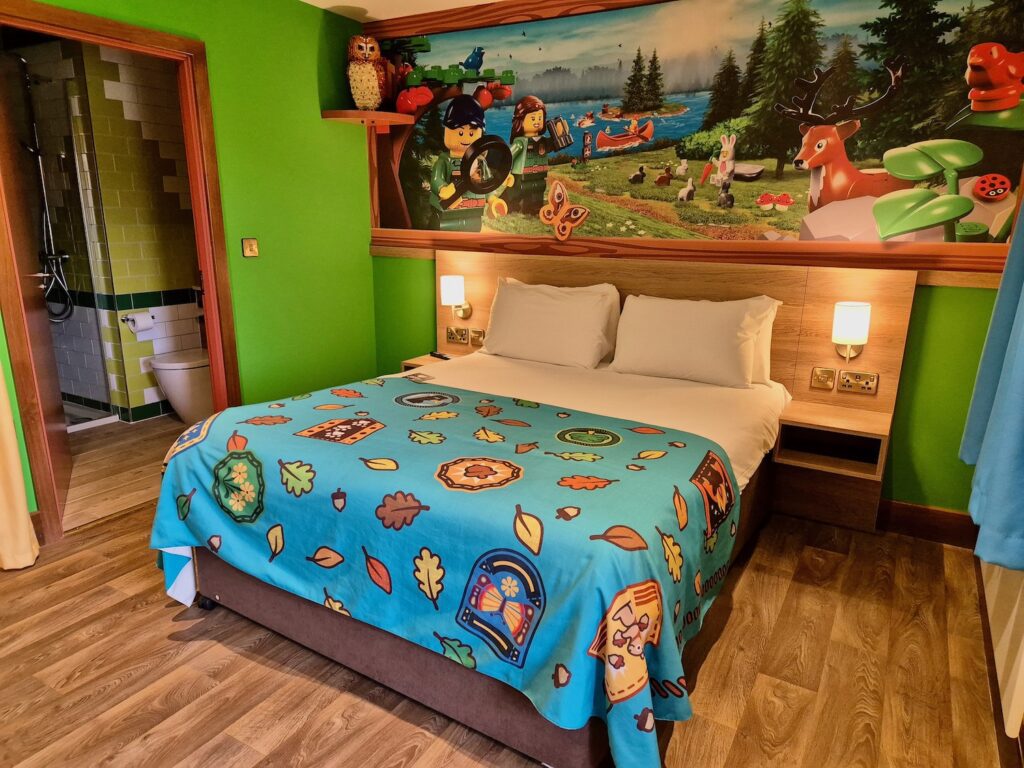 Double bed in a woodland lodge at Legoland's Woodland Village