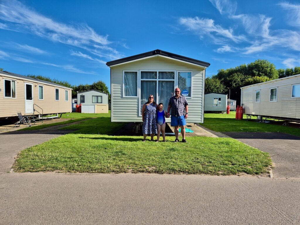 Family photo outside Haven Cleethorpes Beach bronze caravan