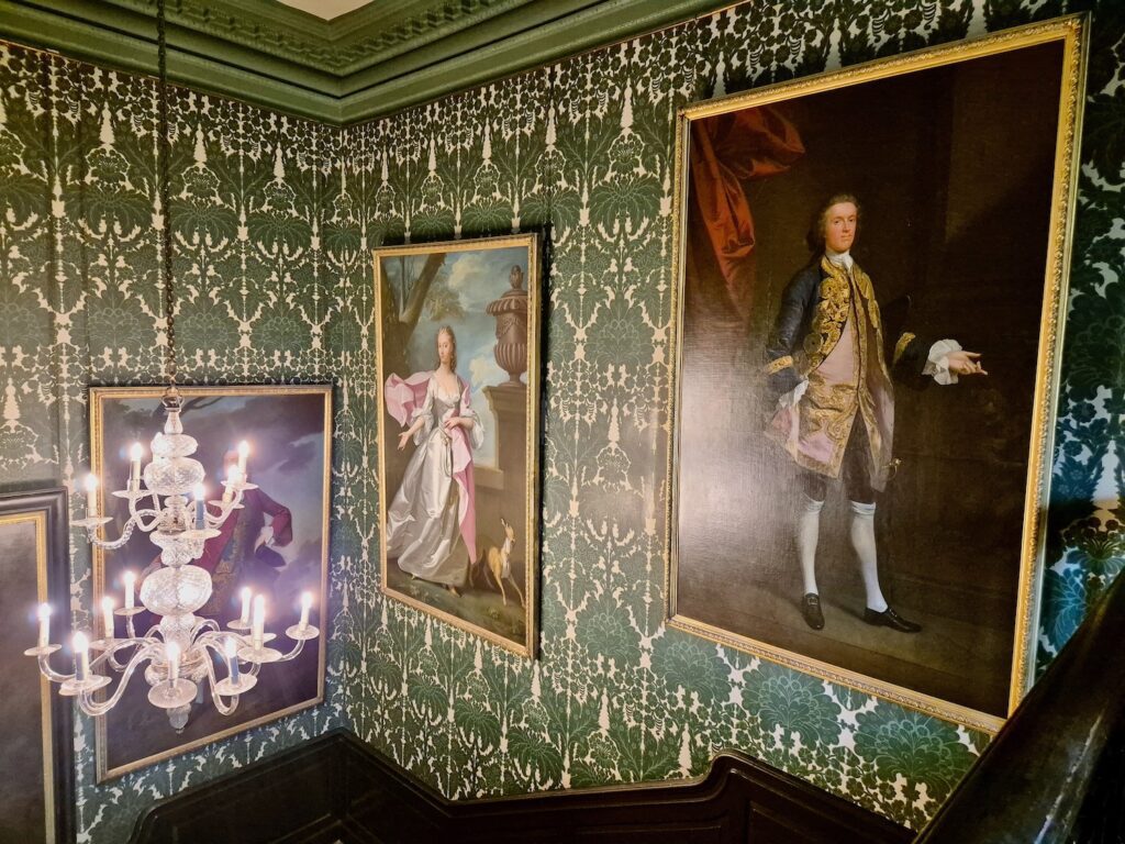 View of portraits on the wall and a chandelier at Treasurer's House