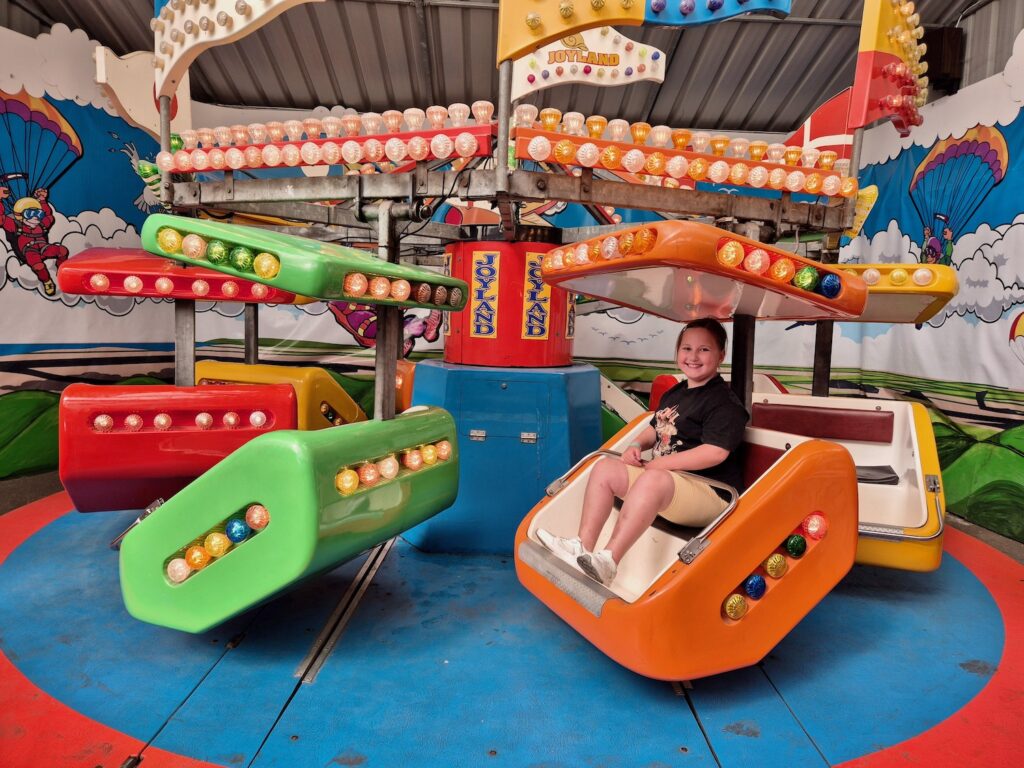 Erin riding the Junior Skydiver at Joyland