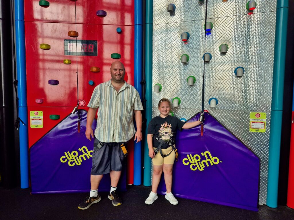 John and Erin in harnesses at Clip 'n Climb