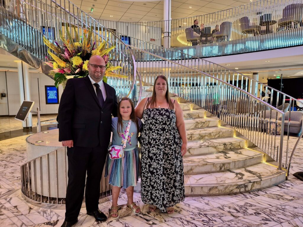 Family of 3 dressed up in formal wear for Celebration night on P&O Iona