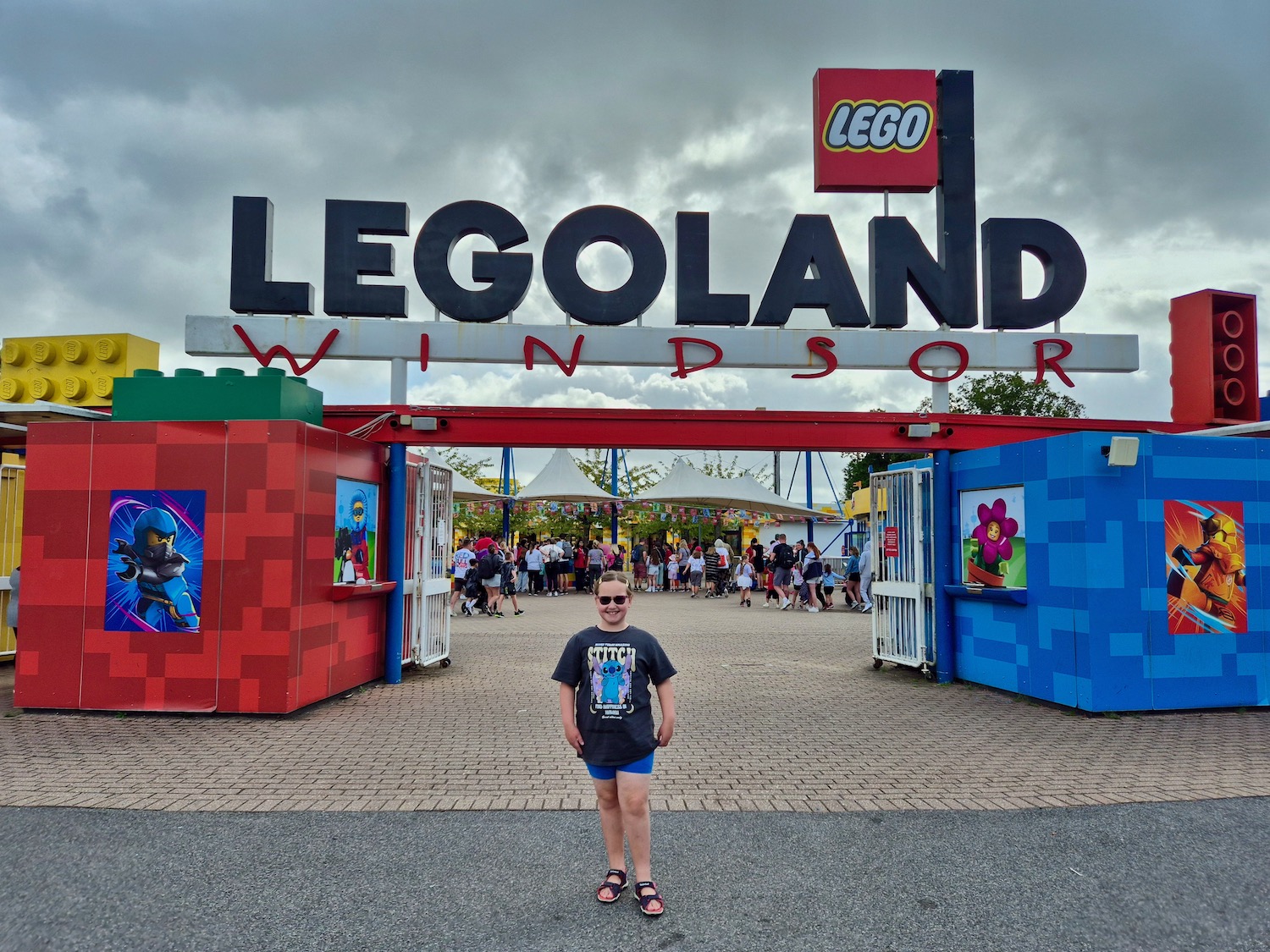 An 8 year old girl standing at the entrance to Legoland Windsor