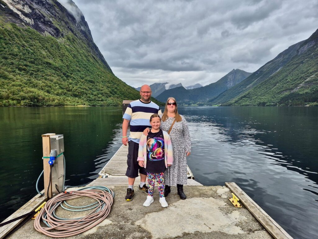 John, Lyndsey and 8 year old daughter Erin stood on a dock in the Norwegian Fjords