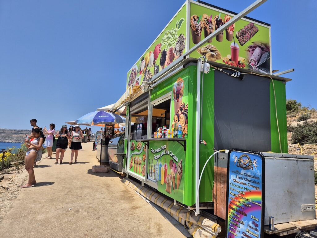 Colourful food stall serving ice creams, smoothies and snacks near the Blue Lagoon in Comino, Malta