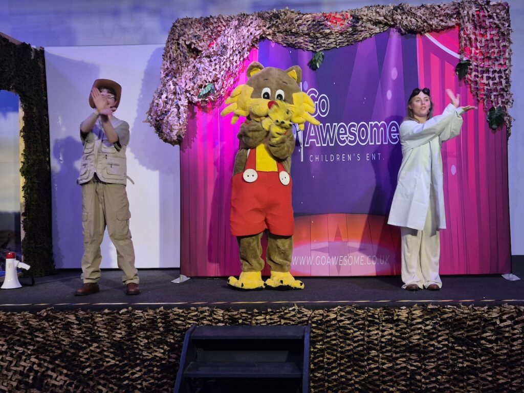 Children’s performers and mascot on stage at the Go Awesome entertainment show