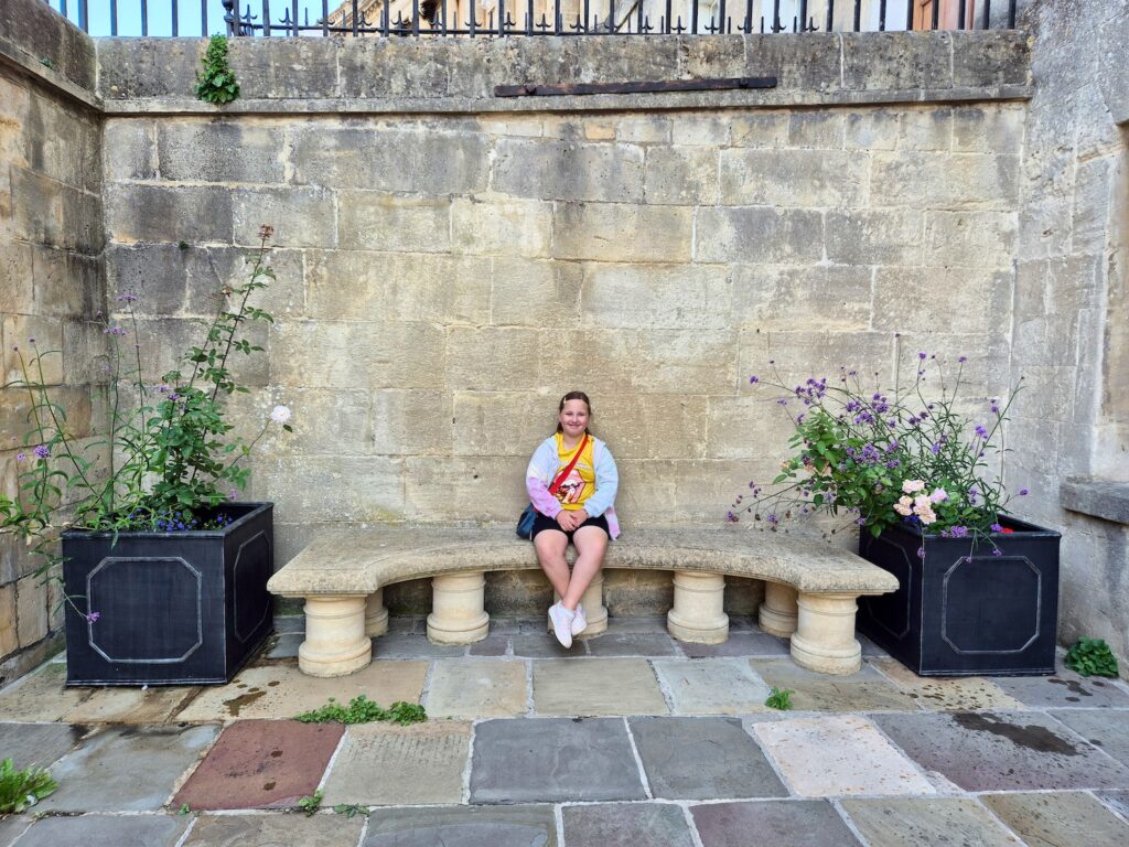 Child sitting on a stone bench in the courtyard of No. 1 Royal Crescent in Bath