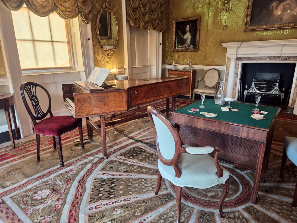 Georgian drawing room with piano, card table, and portraits at No. 1 Royal Crescent in Bath