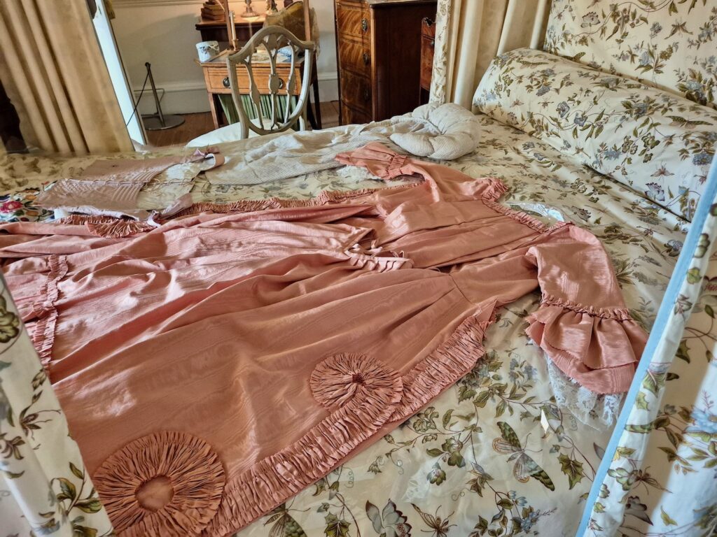 Pink Georgian dress laid out on a four-poster bed inside No. 1 Royal Crescent in Bath
