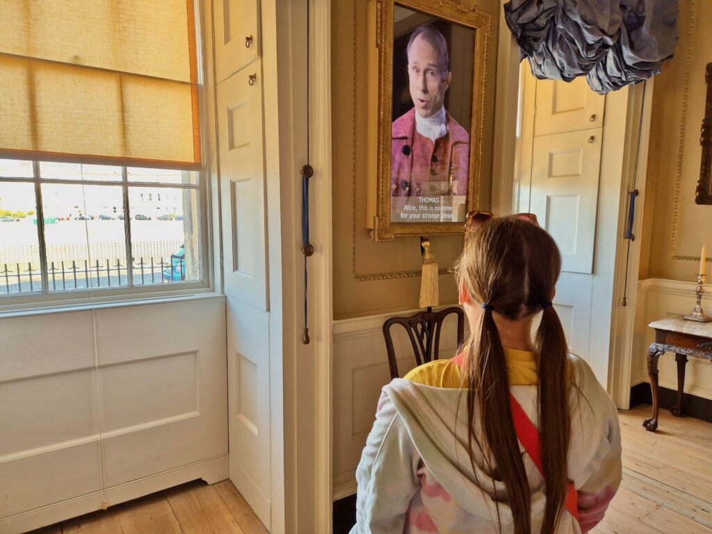 Child watching an interactive storytelling display inside No. 1 Royal Crescent in Bath