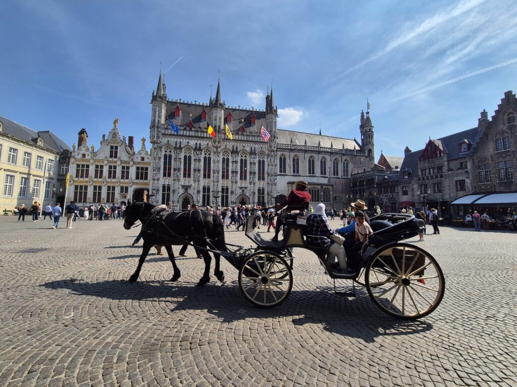 Horse and cart ride in a square in Bruges