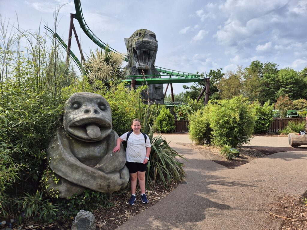 10 year old girl stood in front of Mandrill Mayhem at Chessington