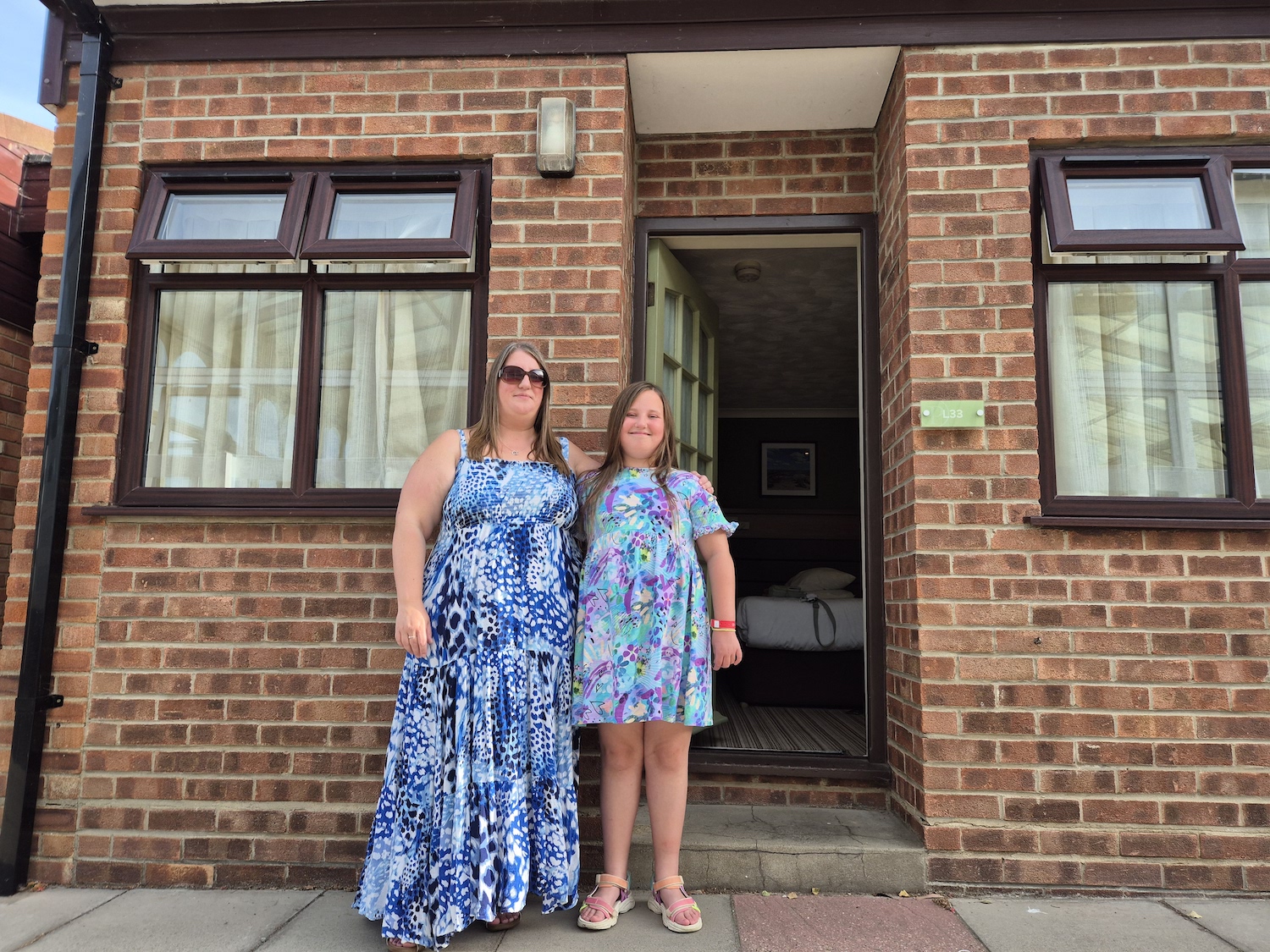 Mother and daughter stood outside bungalow at Potters Hopton on Sea